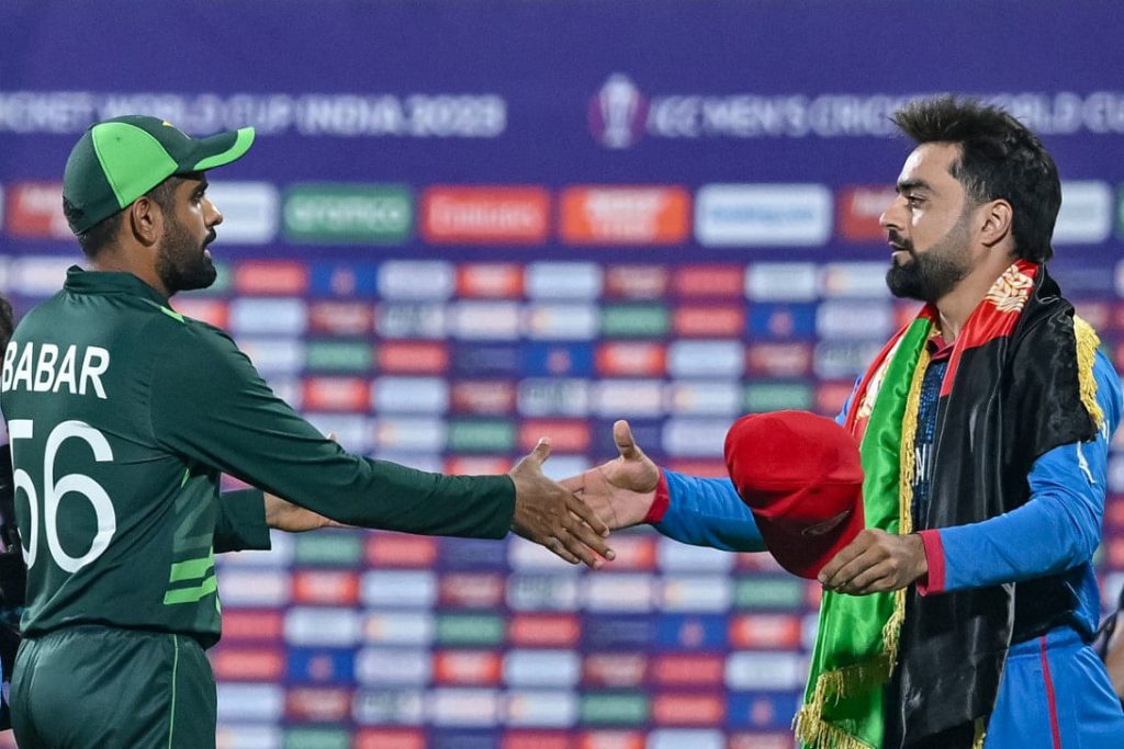 Rashid Khan (on the right) shakes hands with Babar Azam at the conclusion of the Pakistan-Afghanistan fixture in Chennai on October 23, 2023. Photo: AFP